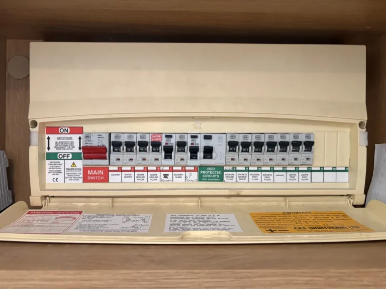 A consumer unit with clearly labelled circuits fitted inside a cupboard