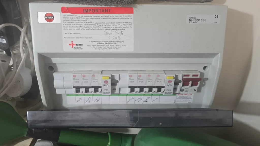 A consumer unit opened up for inspection during an electrical installation condition report