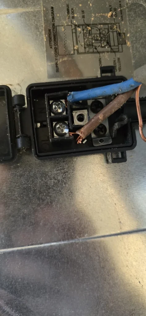 Cable disconnected from the back of an oven, connection unit
