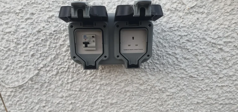 Two weatherproof outdoor sockets fitted to a rendered exterior wall